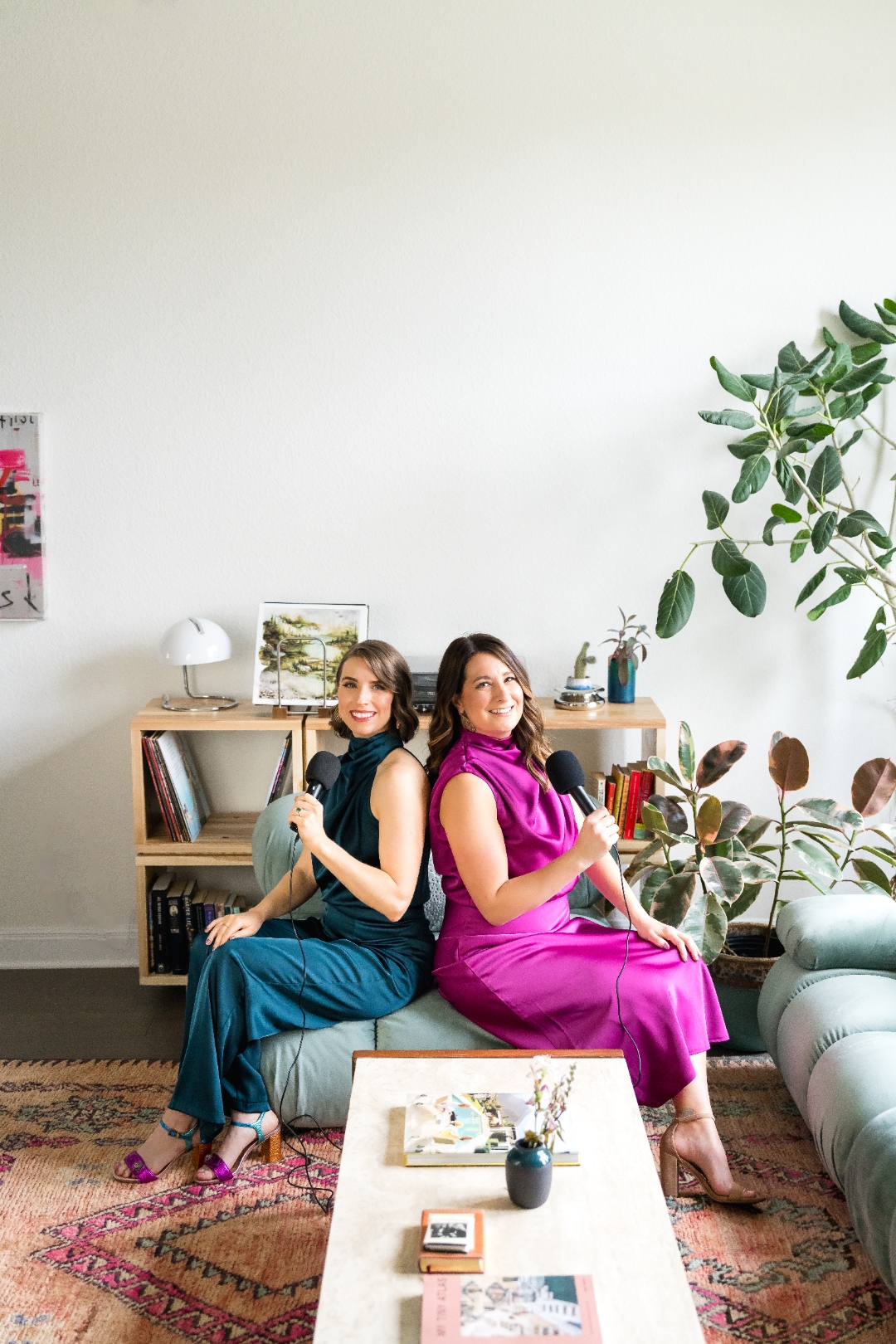 Robin Welch and Deborah Andrews smiling with microphones in their podcast studio
